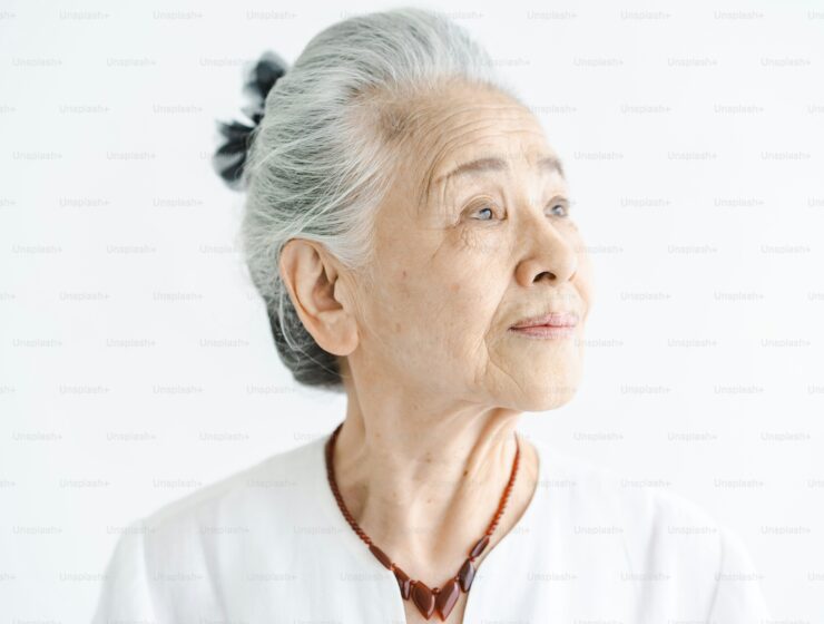 A photograph of an elderly Asian woman.