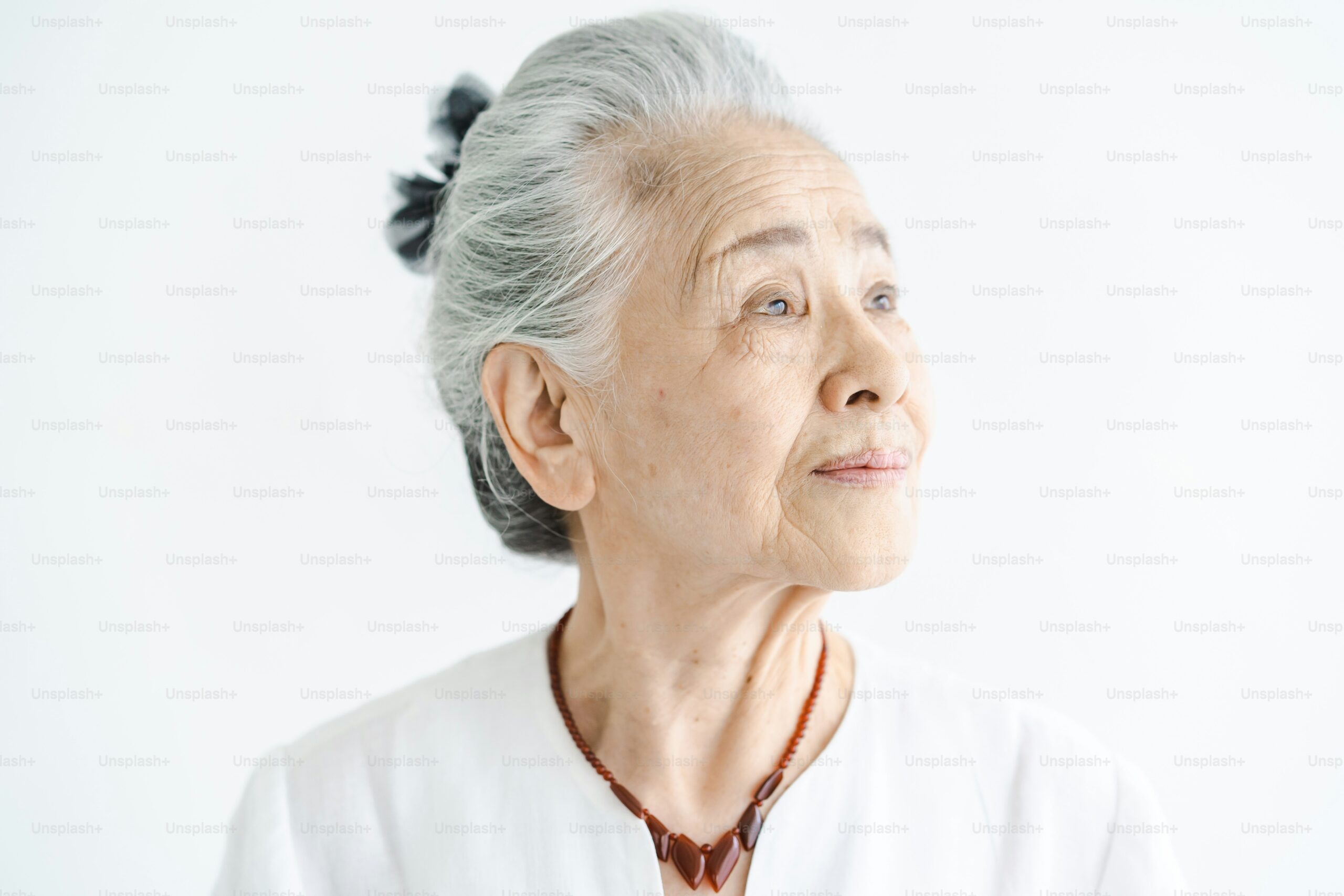 A photograph of an elderly Asian woman.